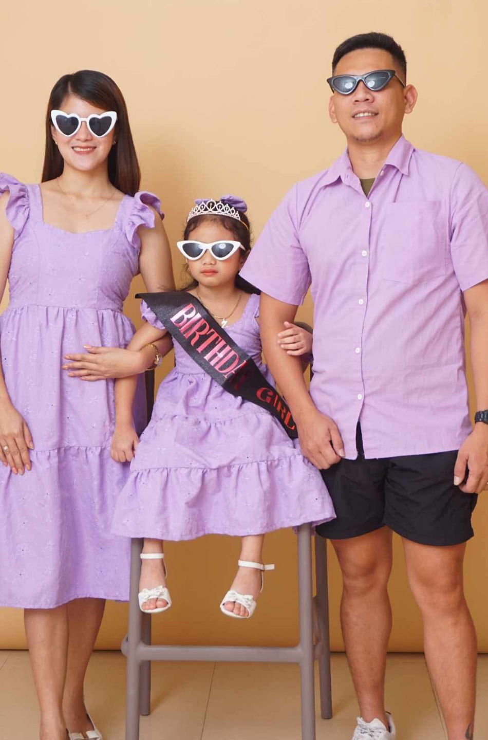 Smiling family modeling MiniMe boutique outfits